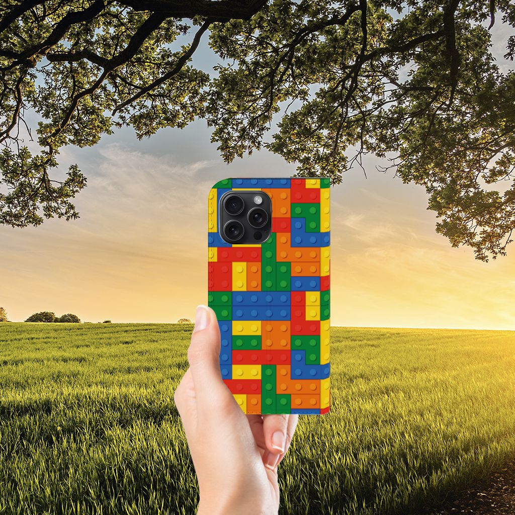 iPhone 15 Pro Max Hoesje met Magneet Blokken in kleurrijk Lego ontwerp, vastgehouden in een hand 🌈.