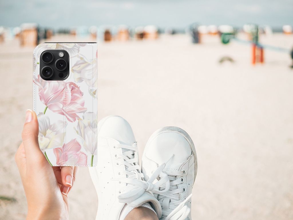 iPhone 15 Pro Smart Cover Lovely Flowers in hand at the beach, showcasing pink flowers design with sneakers.
