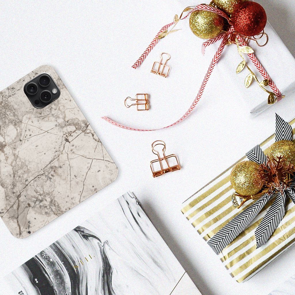 iPhone 15 Pro Standcase Marmer Beige met marmerdesign tussen cadeaus en decoratie.