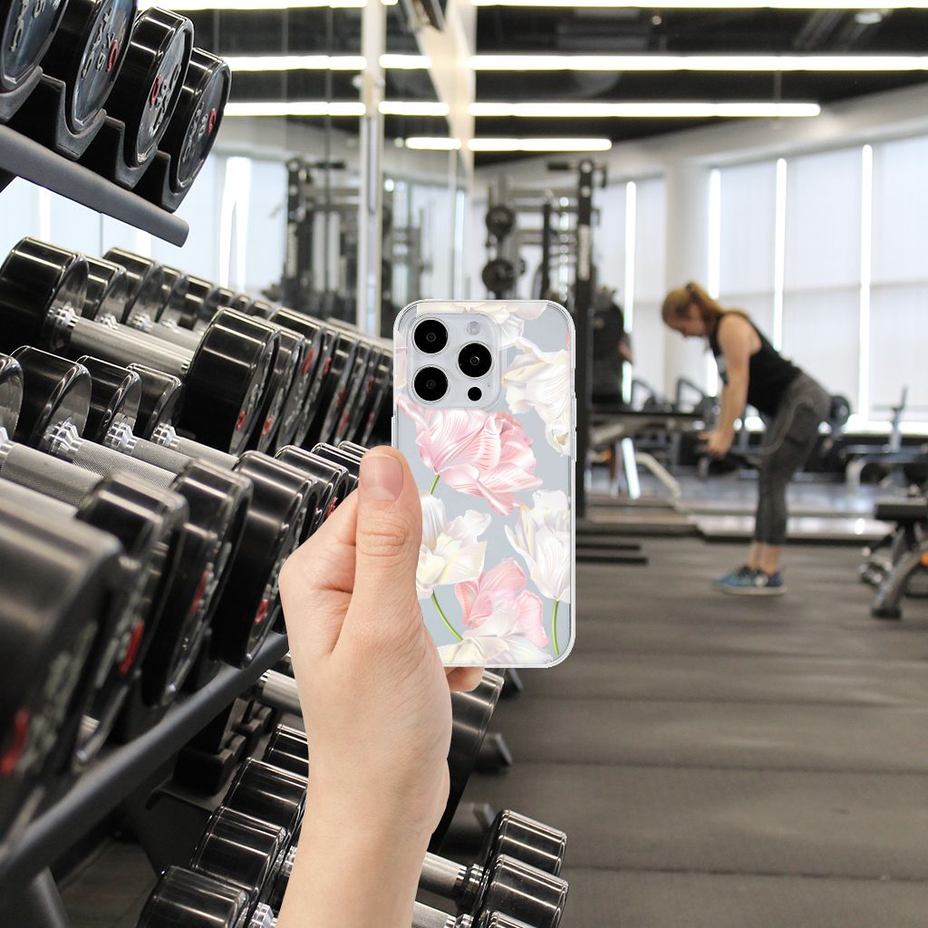 iPhone 15 Pro TPU Case Lovely Flowers in hand at the gym amongst dumbbells, adding a touch of beauty to workouts.