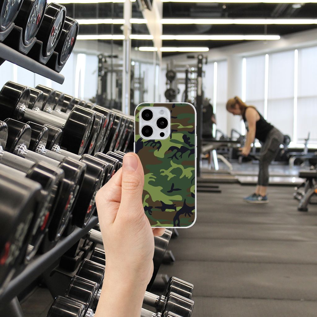 iPhone 15 Pro TPU bumper Army Dark in hand at gym with weights in the background, showcasing a trendy camouflage design.